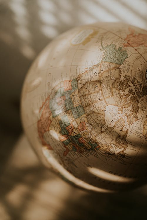Close-up of a Globe Standing on a Desk in Sunlight 