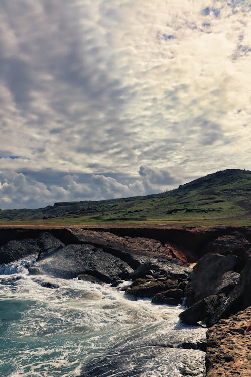 A rocky shoreline with waves crashing into the rocks