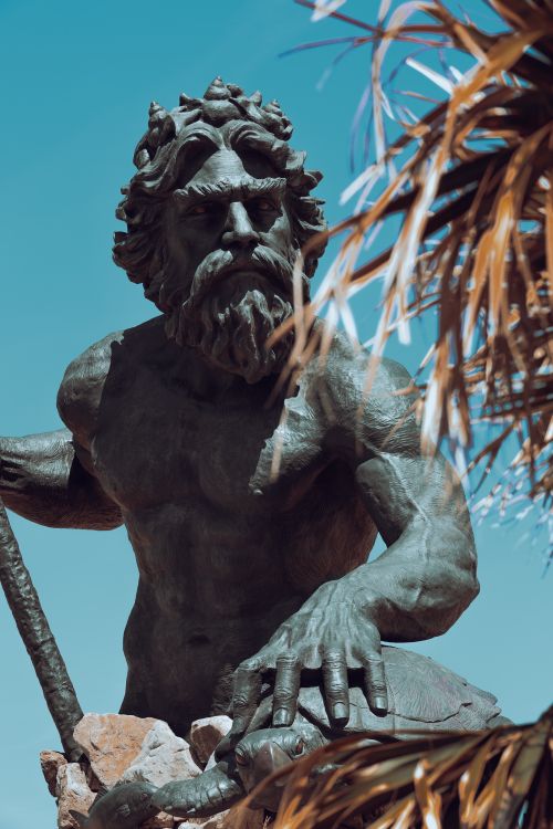 Free Close-up of the bronze Neptune statue against a clear blue sky in Virginia Beach, USA. Stock Photo