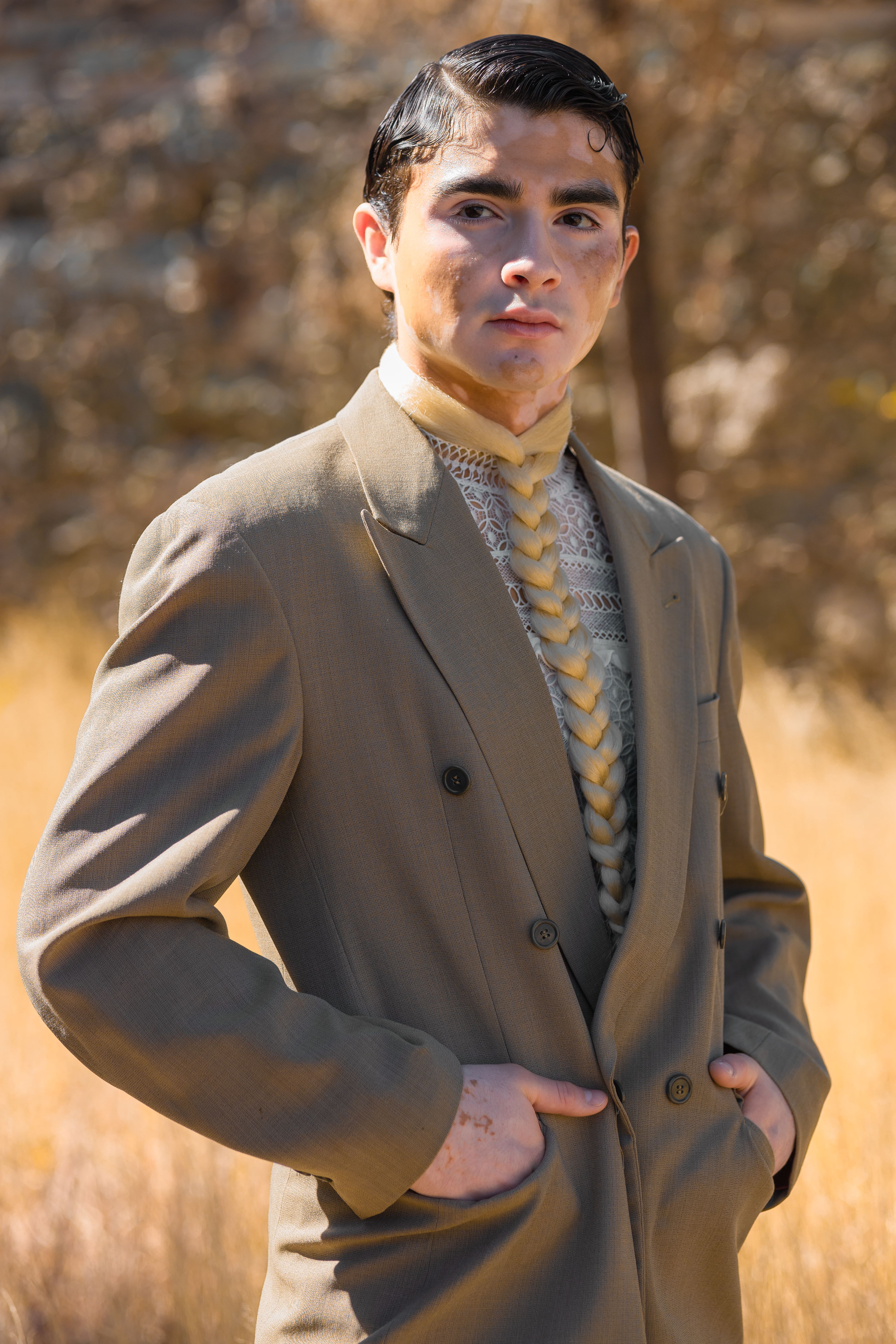 Stylish man in a beige blazer posing in a sunny field, Guanajuato.