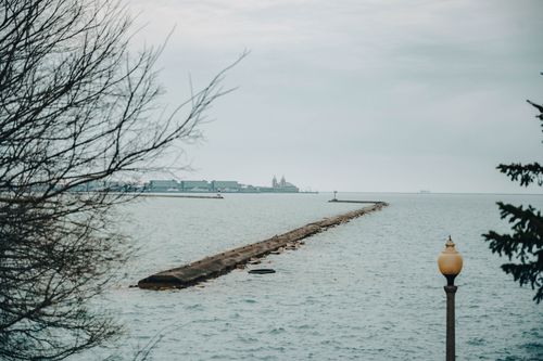 Free Serene view of the pier extending into Lake Michigan from Chicago's scenic lakeshore. Stock Photo