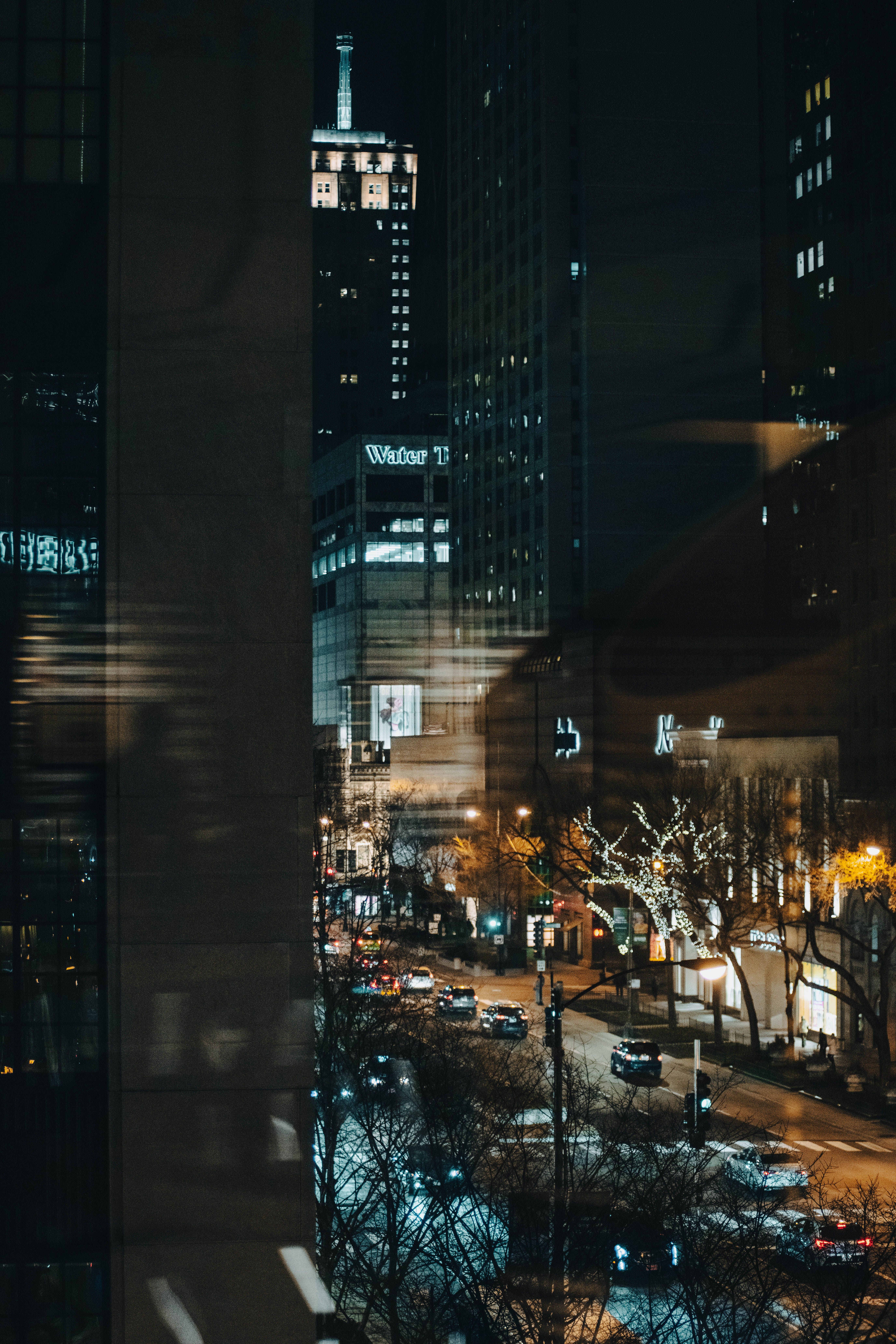 Explore the vibrant city streets of Chicago at night with dazzling skyscrapers and urban life.