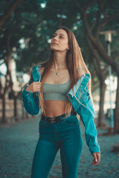 Woman Standing Between Trees