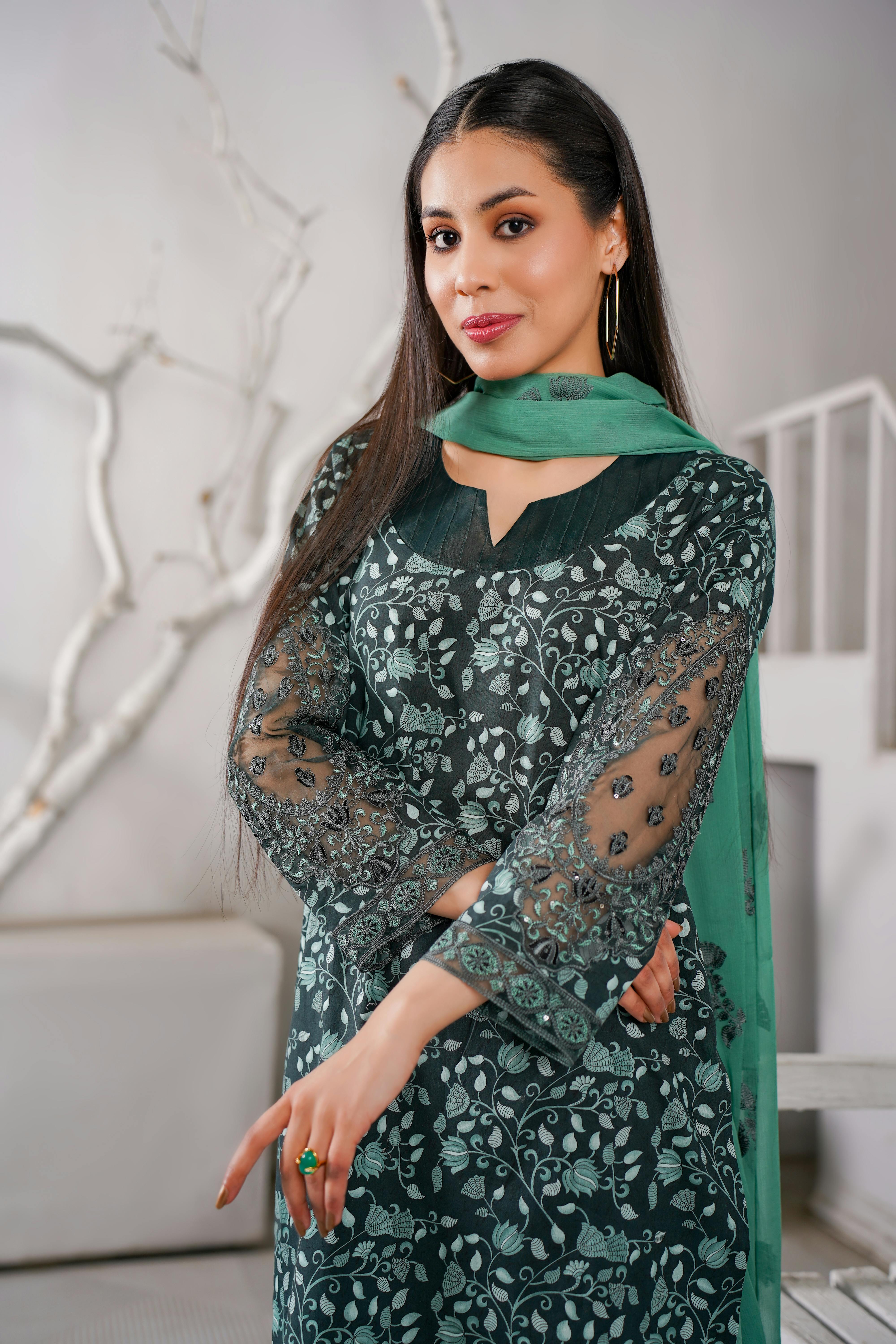 photo of a brunette wearing a green floral patterned dress