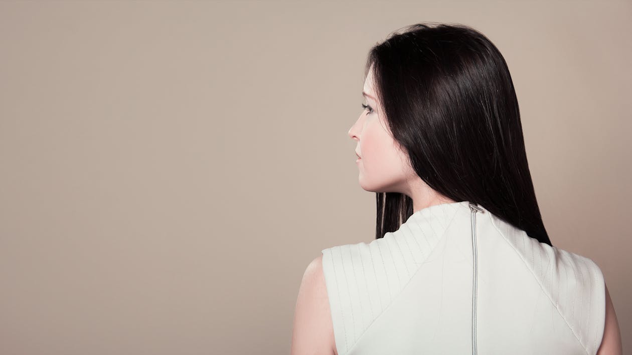 Free Woman in White Sleeveless High Neck Top Showing Her Back Stock Photo