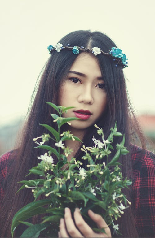 Free Woman Holding Flowers during Day Stock Photo