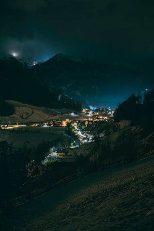 A night scene of a small town with lights on