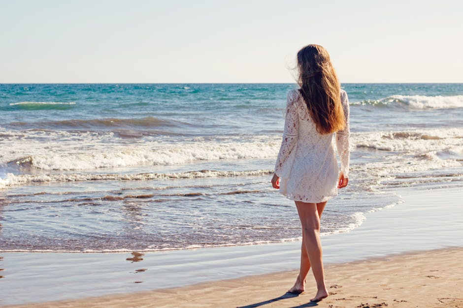Woman in White Lace Long Sleeves Dress on Seashore