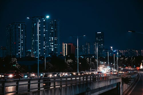 A city at night with cars and lights on the highway