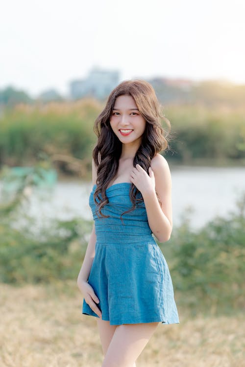 A young asian woman in a blue dress posing for a photo