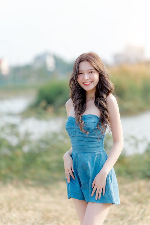 A young woman in a blue dress posing for a photo
