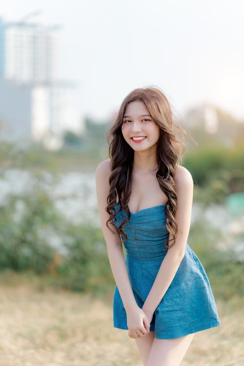 A young woman in a blue dress posing for a photo