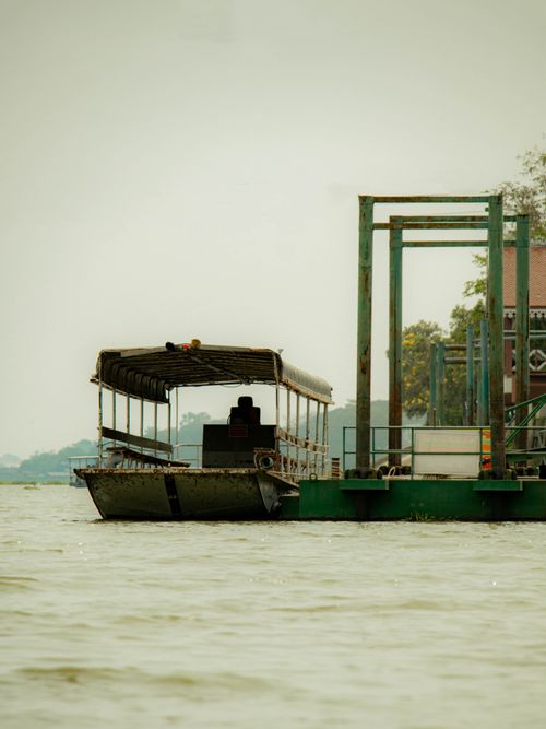 Free A traditional boat docked at a rural pier on Chao Phraya River in Ayutthaya, Thailand. Stock Photo