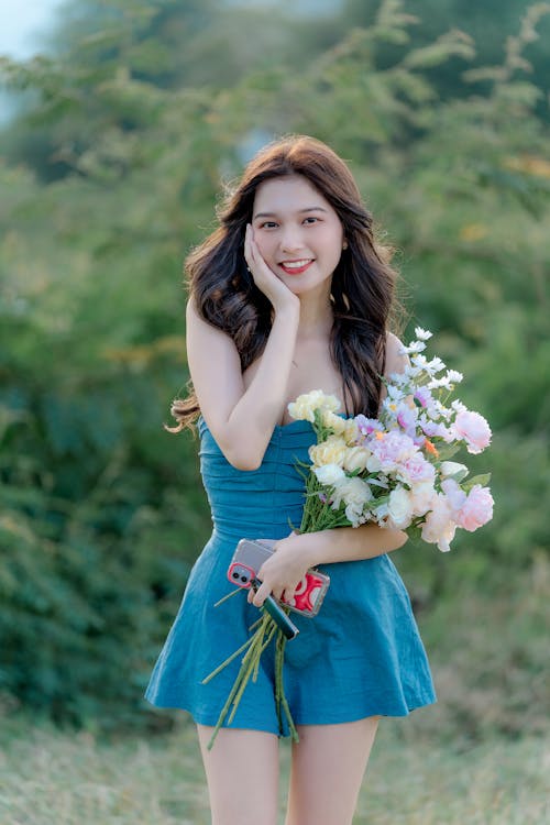 Brunette Woman with Blue Dress and Bouquet of Flowers 