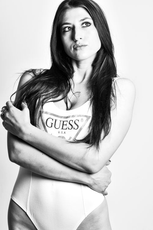 Free Monochrome portrait of a woman posing in a swimsuit, showcasing fashion and elegance. Stock Photo
