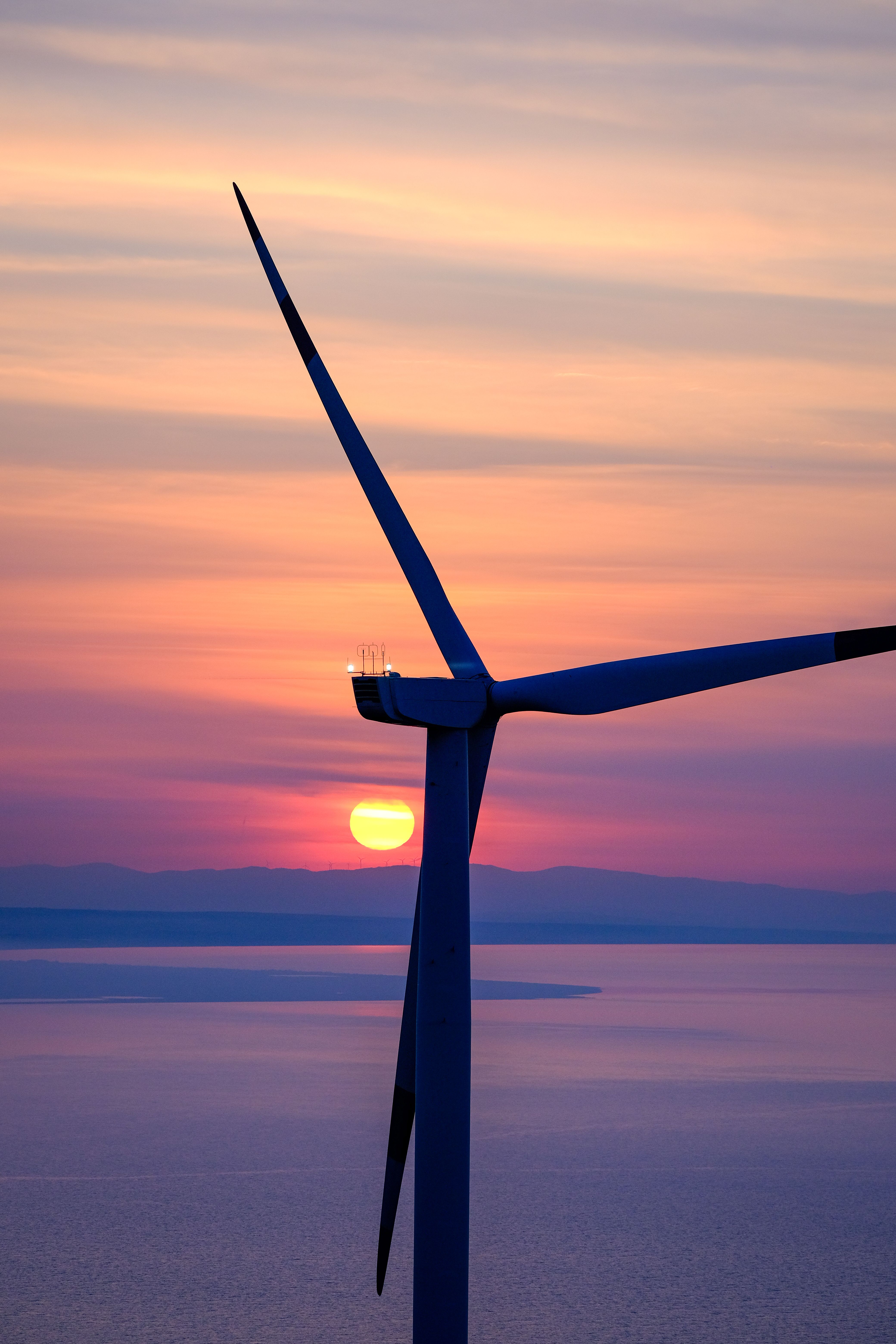 Wind Turbine on Sea Coast at Sunset · Free Stock Photo