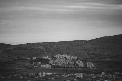 A black and white photo of a village on a hill