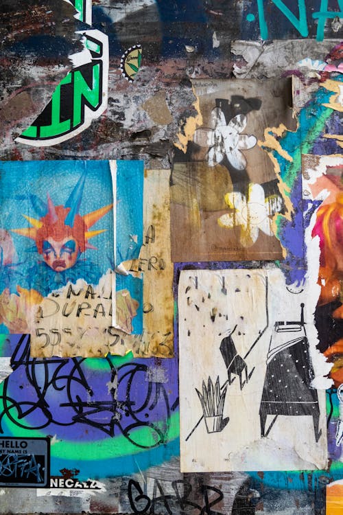 A collage of graffiti and other art on a wall