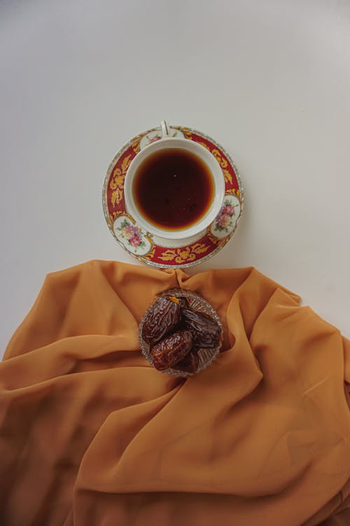 A cup of tea sits on top of a cloth