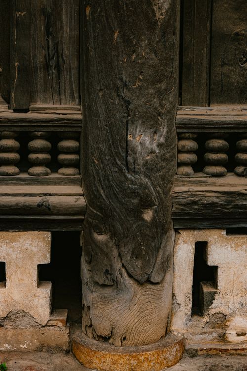 Free Close-up of a weathered wooden post with intricate carvings in an ancient structure. Stock Photo