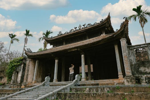 Beautiful Vietnamese temple with intricate architecture and palm trees in Hanoi, Vietnam.