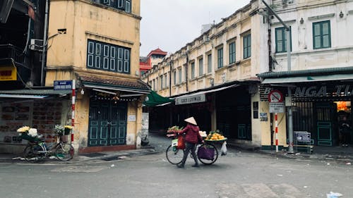 Woman Leading Bike with Shopping