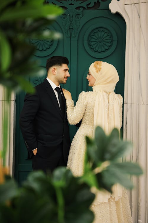 Newlyweds Standing by Green Door