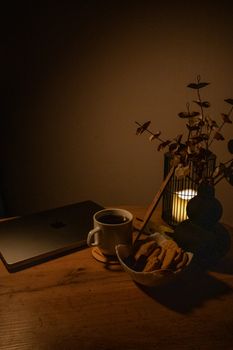 Warm ambient scene featuring a laptop, coffee, and cookies, perfect for cozy mood settings.