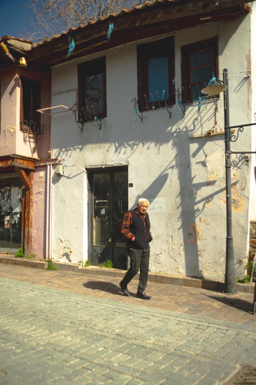 Free A man walking down a street with a backpack Stock Photo