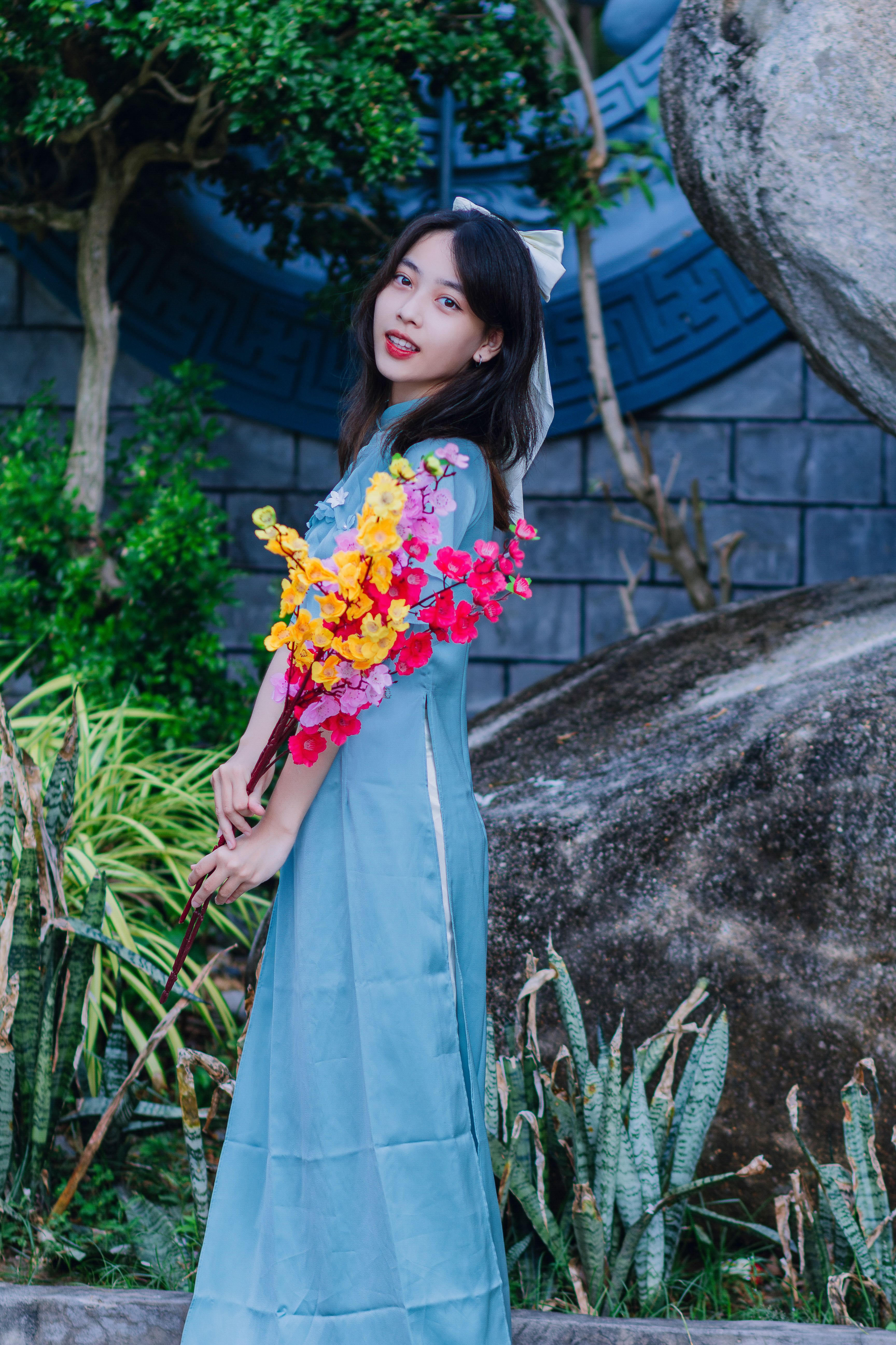 Young Woman in Traditional Blue o Di Dress Outdoors  Free Stock Photo