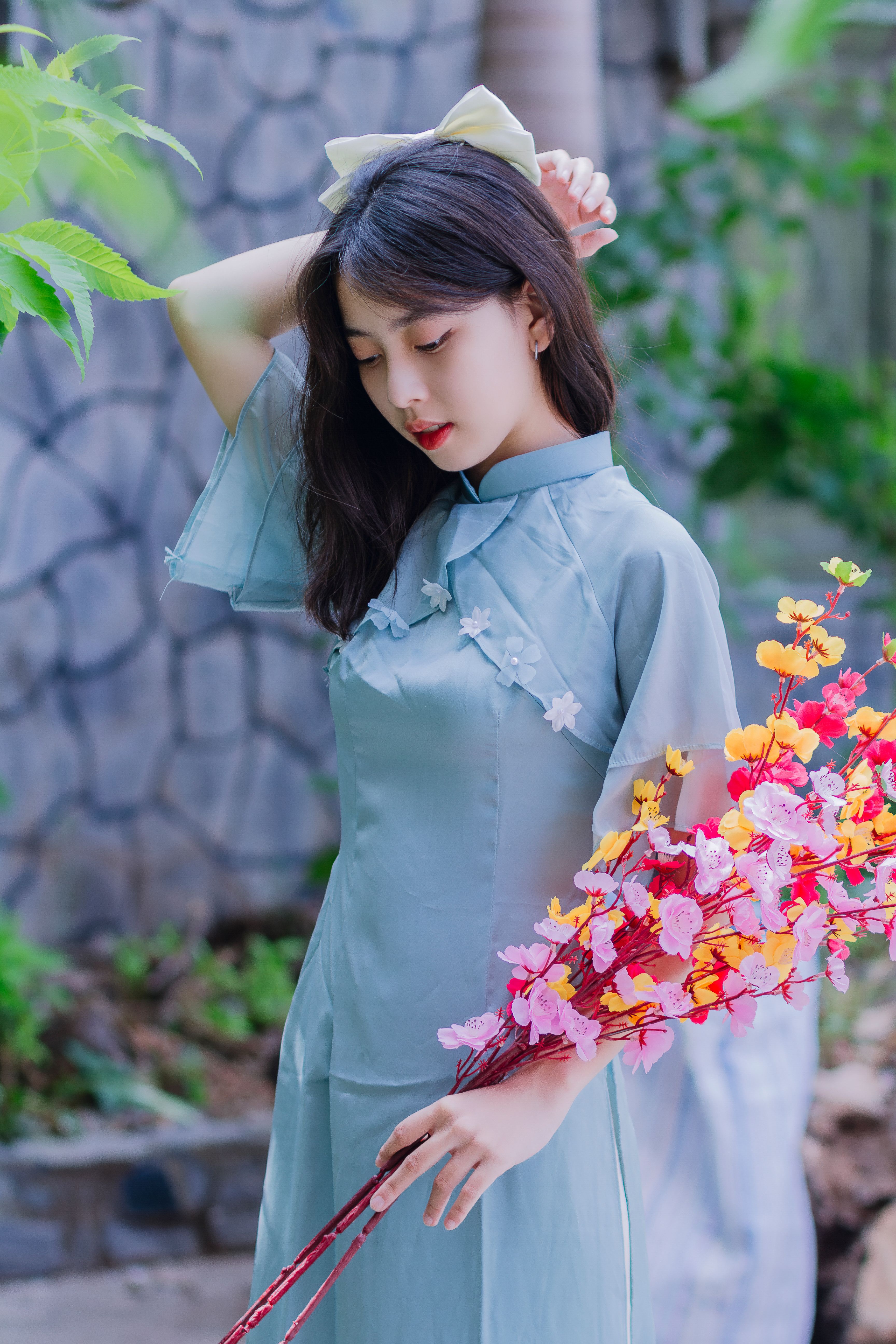 Woman in Traditional Clothing Holding Flowers · Free Stock Photo