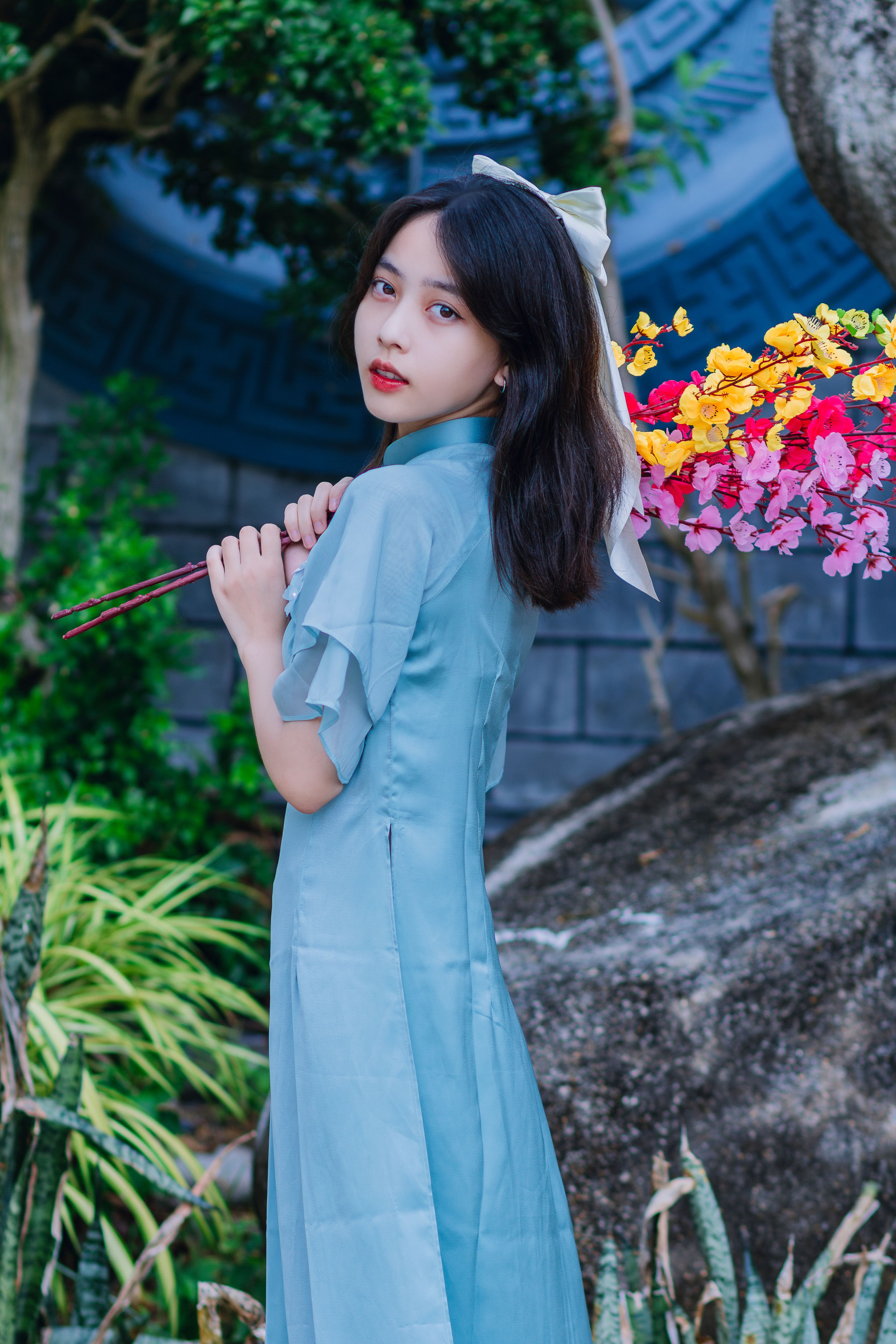 Woman in Traditional Clothing Holding Flowers · Free Stock Photo