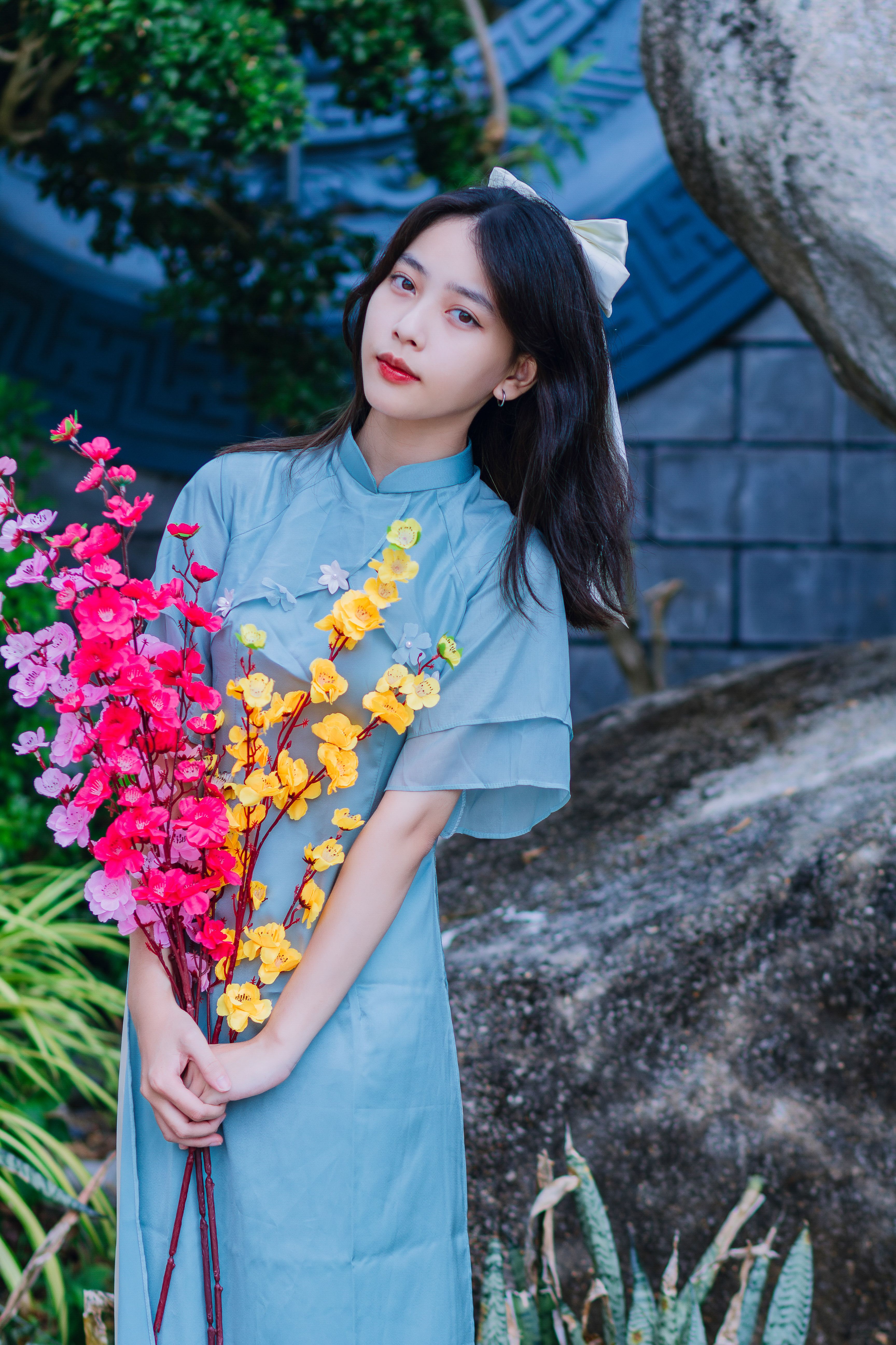 Woman in Traditional Clothing Holding Flowers · Free Stock Photo