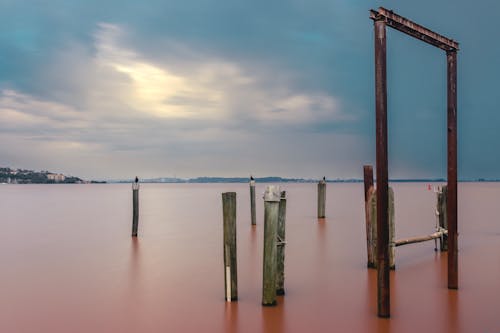 Metal and Wooden Poles in Pink Lake