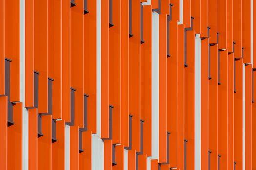 Dynamic modern facade in Rotterdam with striking orange geometric patterns.