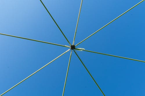 A green umbrella with several wires attached to it