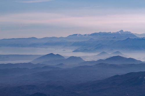 Free A serene view of Montenegro's mountain landscape with misty layers and distant peaks at dawn. Stock Photo