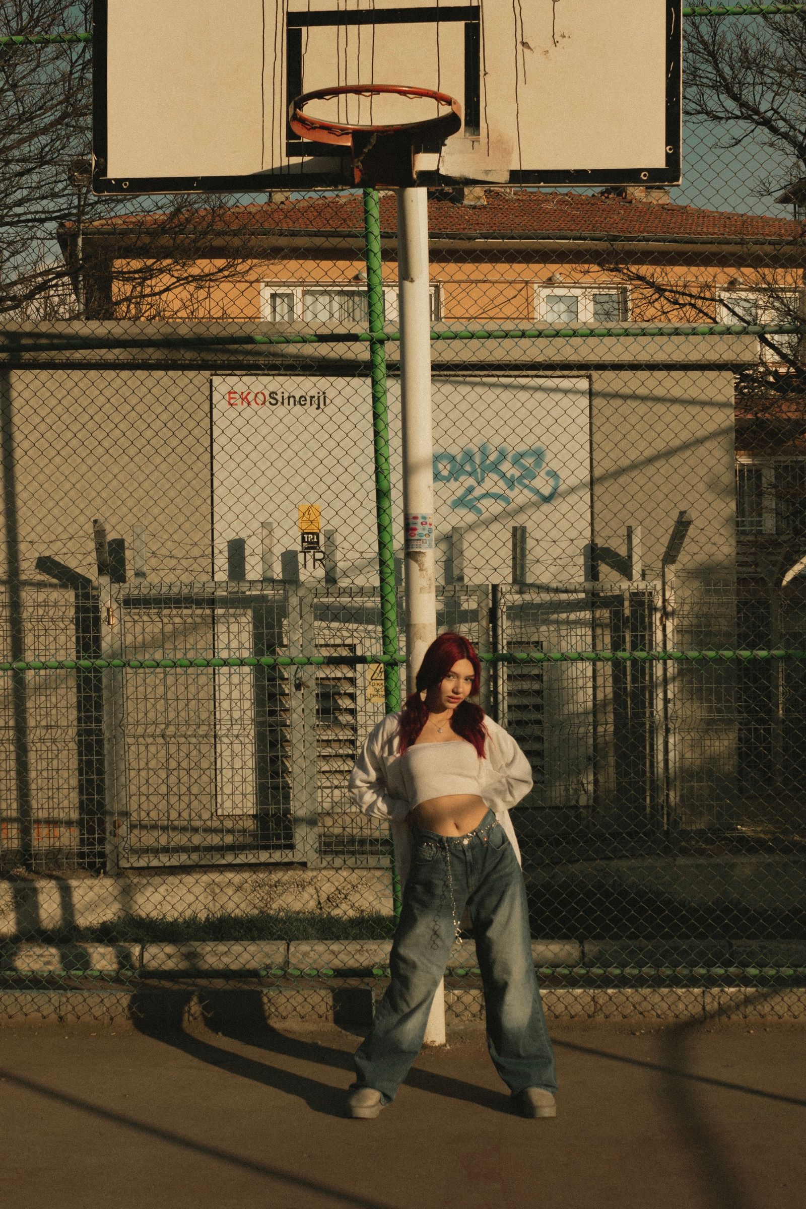 Model in a crop top and baggy jeans, street style portrait
