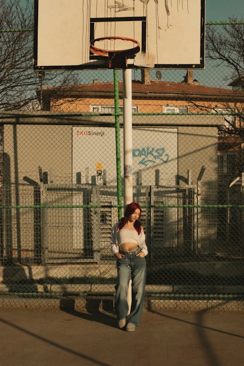 A woman standing in front of a basketball hoop