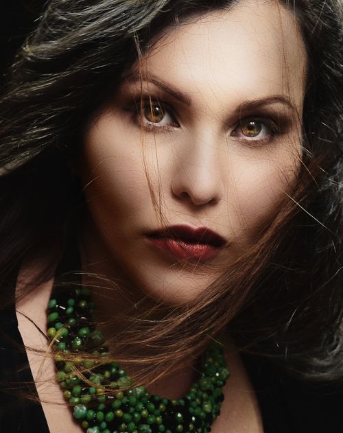 Free Close-up portrait of a woman with captivating eyes and green necklace. Stock Photo