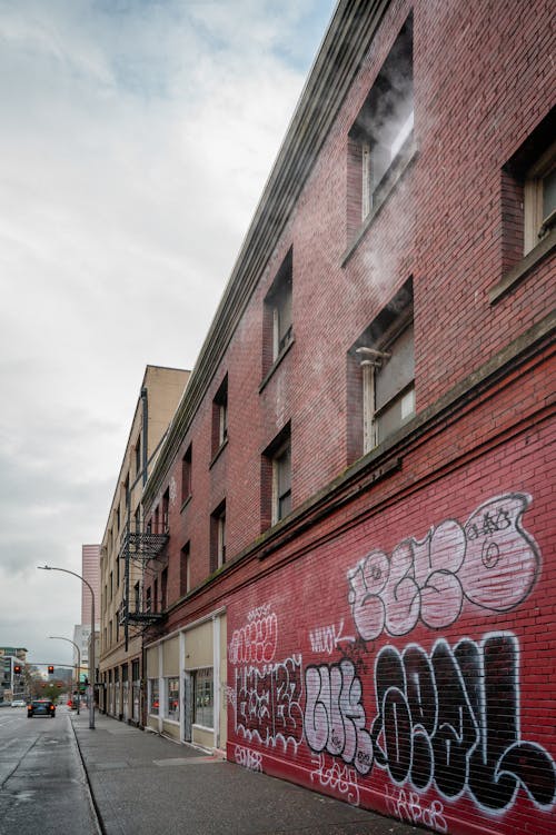 A red brick building with graffiti on it