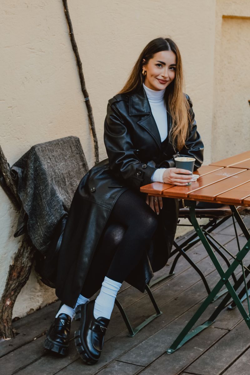 woman in trench coat with black leather pants