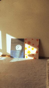 Two art canvases in soft sunlight, creating a warm, serene atmosphere.