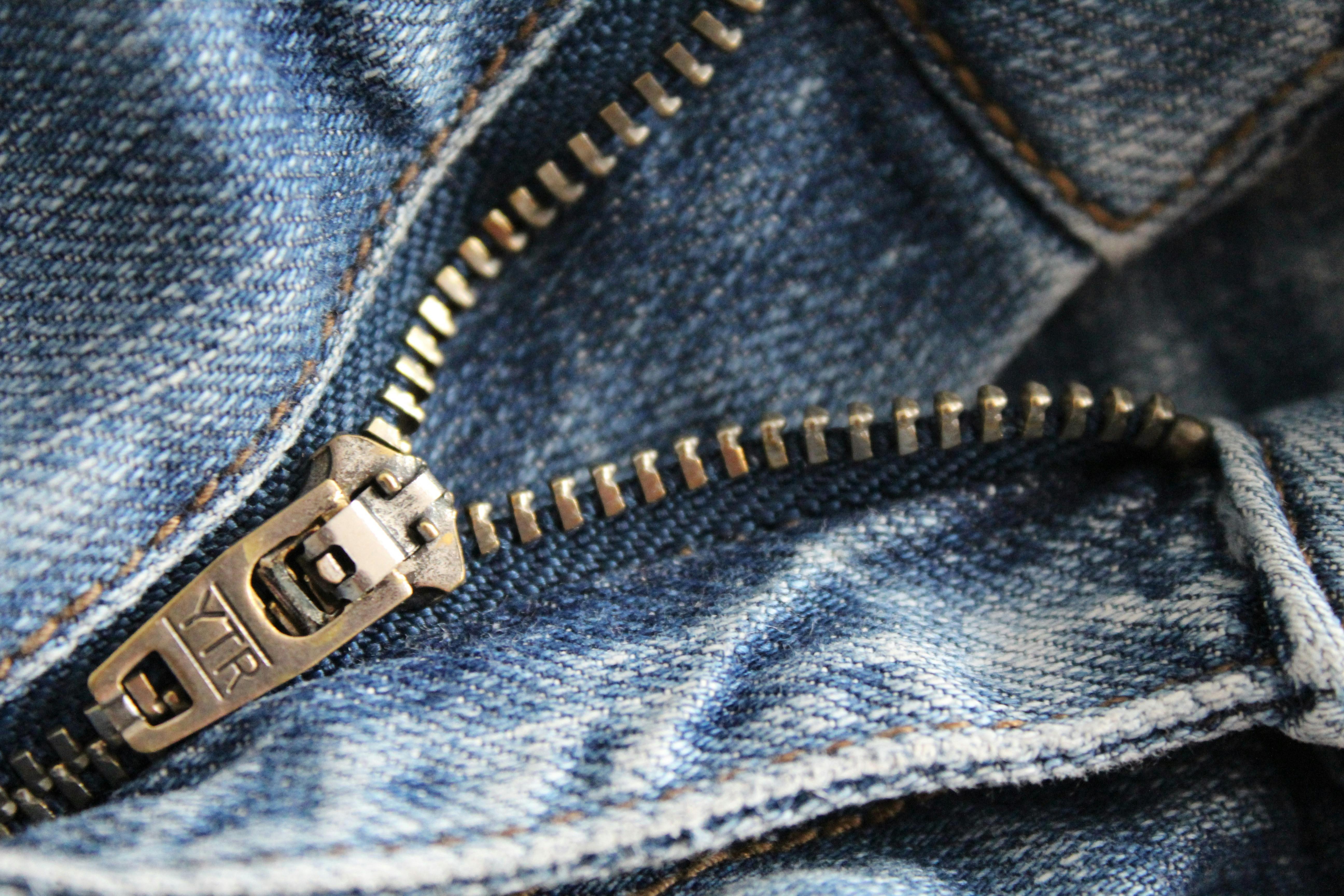 Jeans zipper. Close up of a zip on a pair of blue jeans half