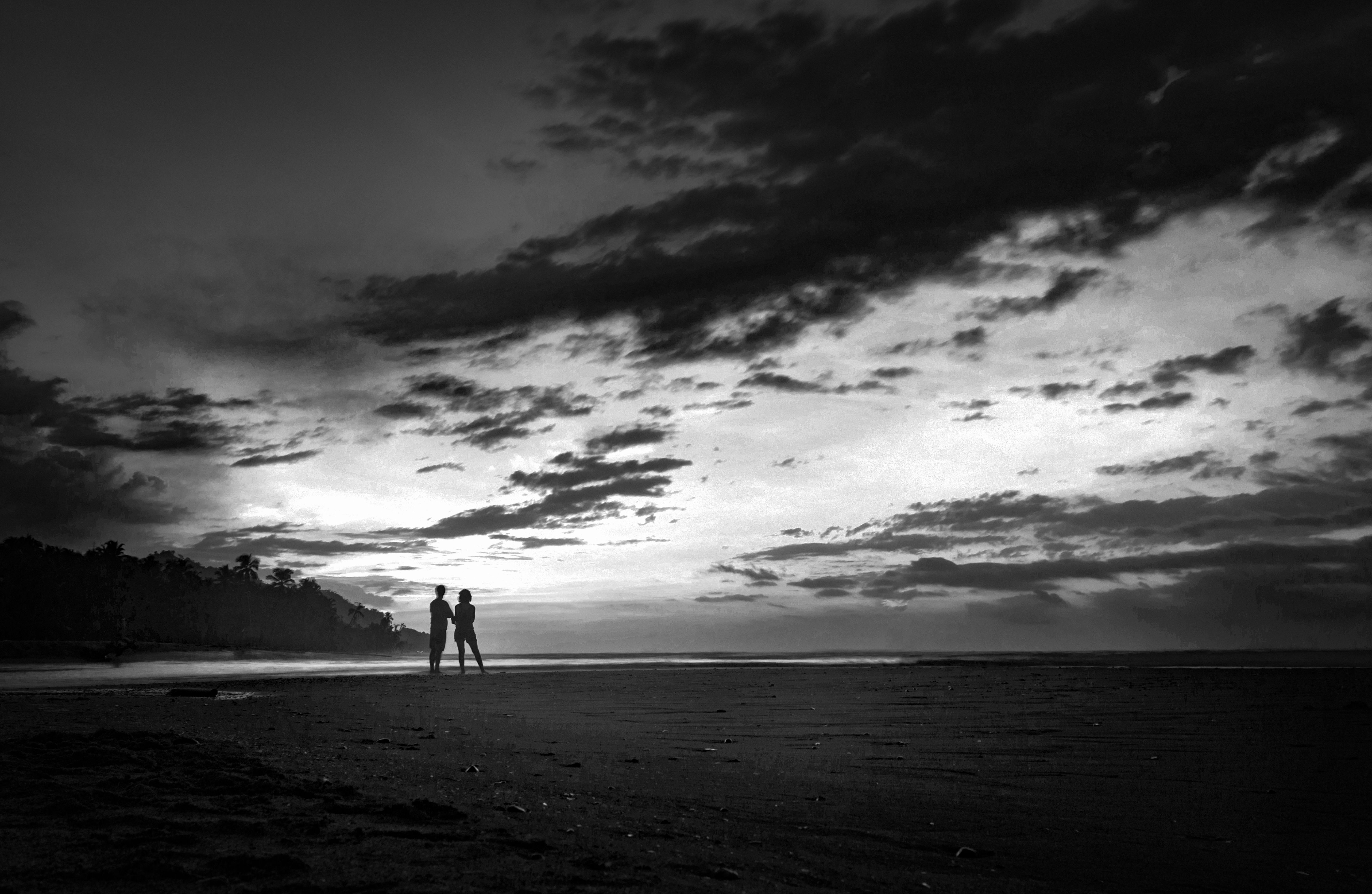 Couple Standing on Beach at Dusk · Free Stock Photo