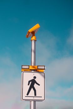 Close-up of a pedestrian sign equipped with a solar panel in Charlottetown, PE, Canada.