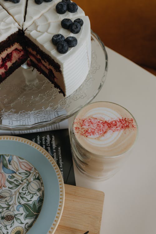 Blueberry Cake and a Glass of Coffee on a Table