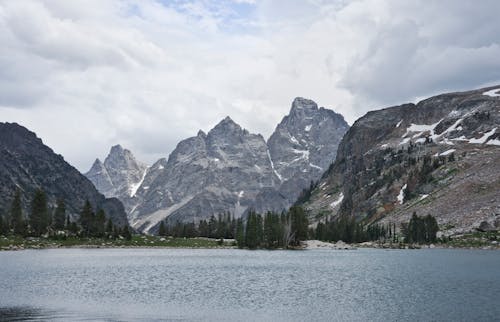 A mountain range is seen from a lake