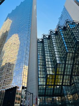 View of towering modern skyscrapers in Toronto with reflective glass facades and urban architecture.