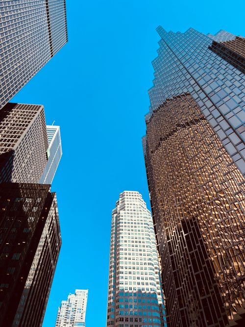 Free A low angle view of Toronto's modern skyscrapers against a clear blue sky, capturing urban architecture. Stock Photo